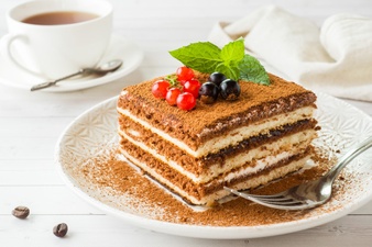 delicious-tiramisu-cake-with-fresh-berries-mint-plate_78677-43