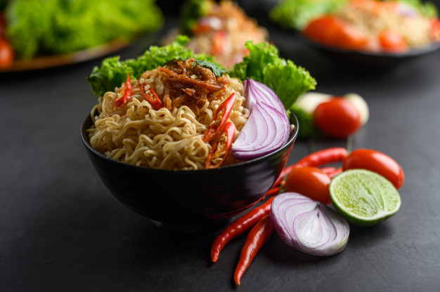 noodles-spicy-bowl-with-ingredients-black-cement-surface_1150-19806